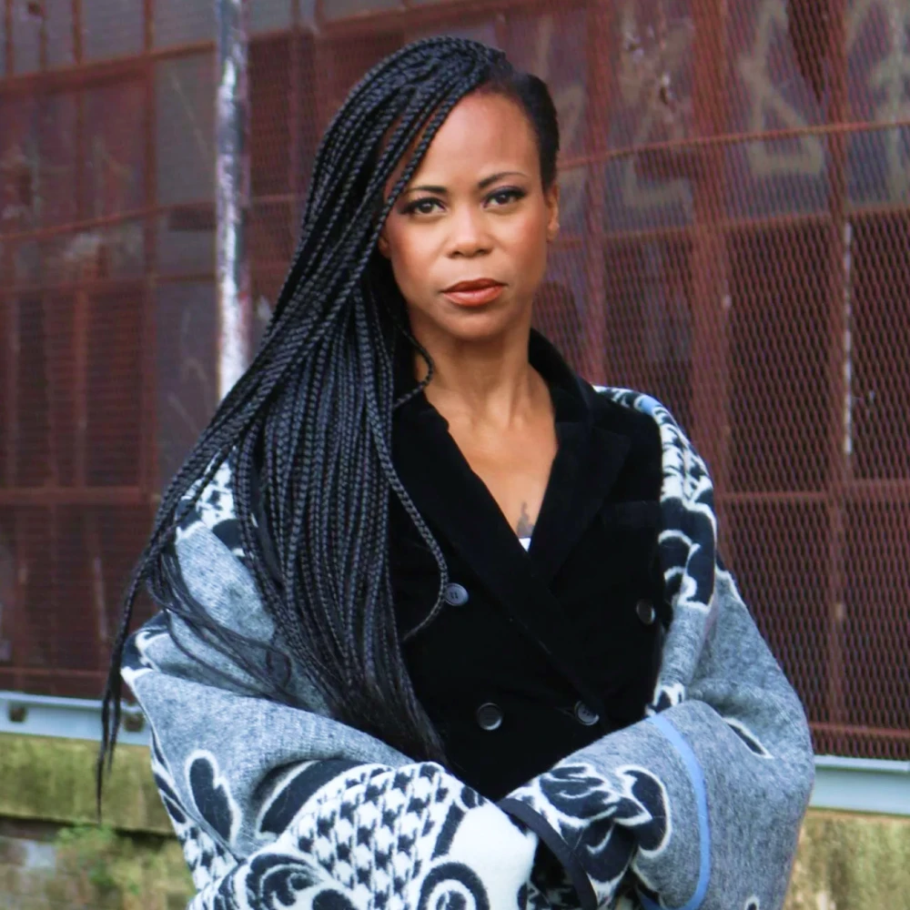 Hannah E. Beachler in front of a fence
