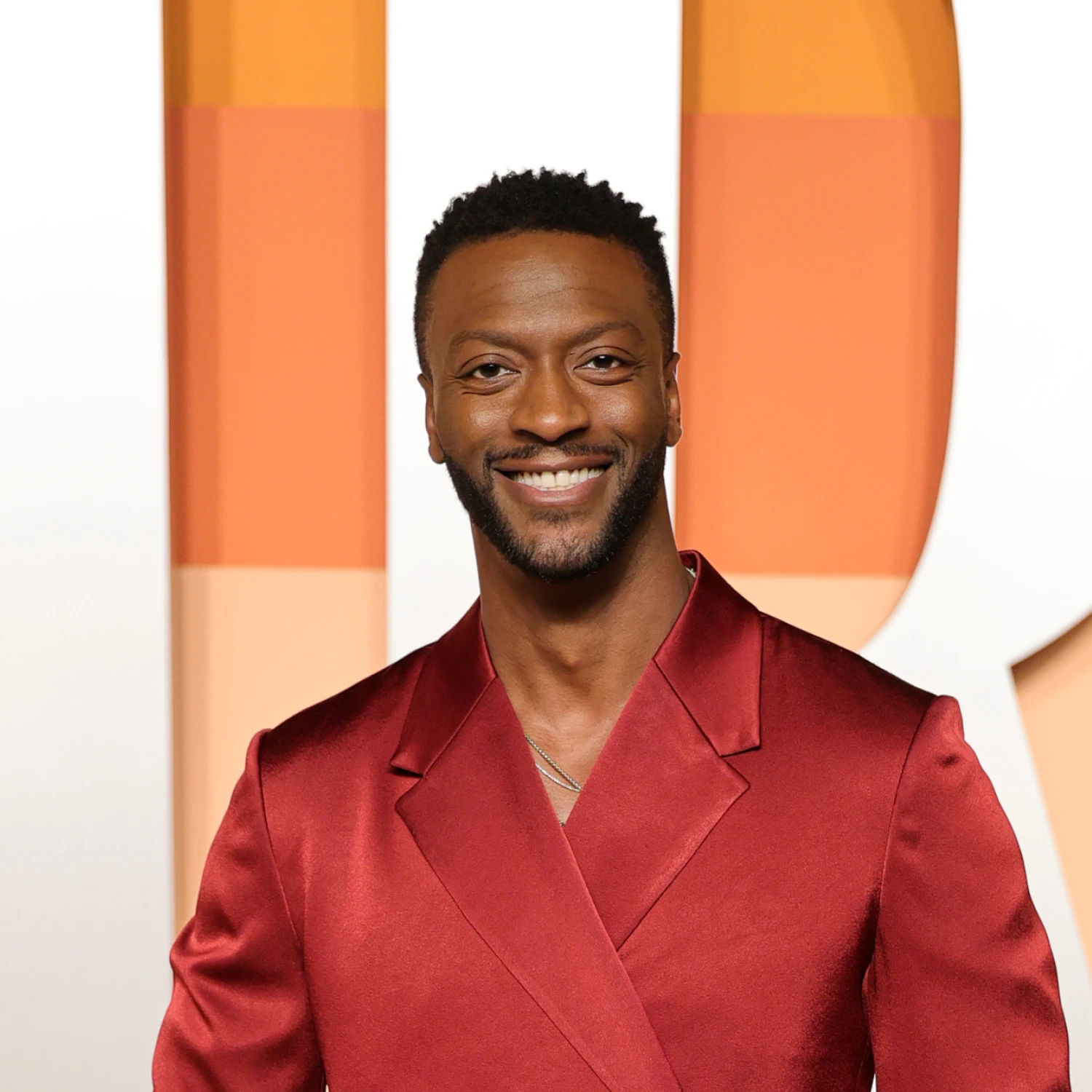 Aldis Hodge standing in front of awards
